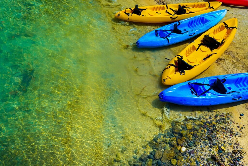 Blue and yellow kayaks by the water
