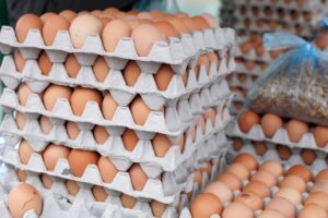 Crates of brown eggs stacked