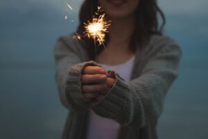 Someone holding out a sparkler firework 